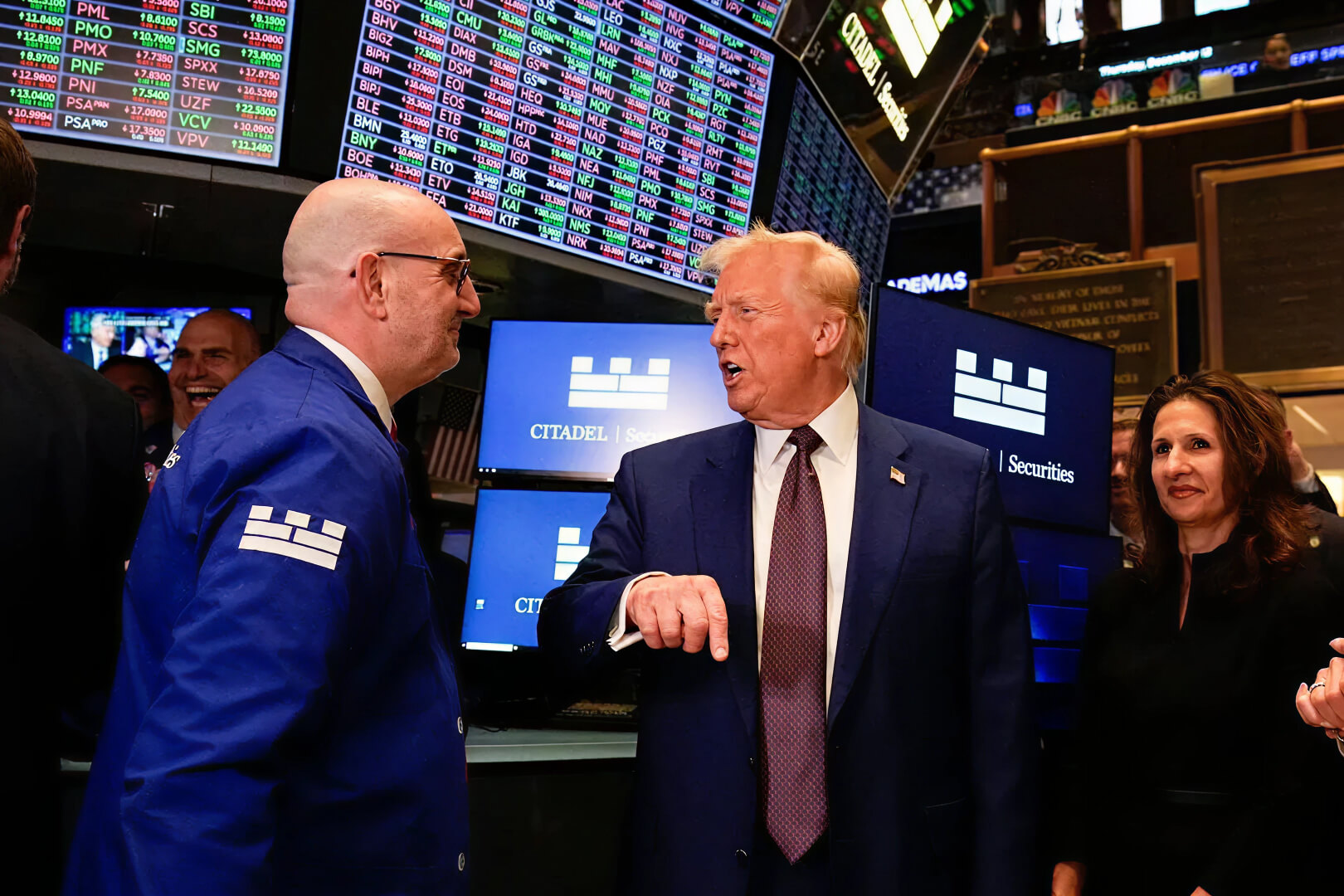 Donald Trump talking to a person at Wall Street